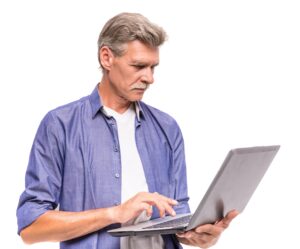 Senior man doing research on computer of what is considered medical necessity in medicare.