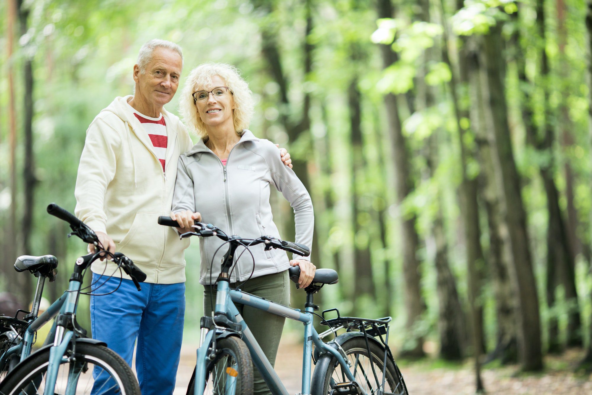Seniors in the forest in Texas biking as they discuss their Medicare Advantage Plan.