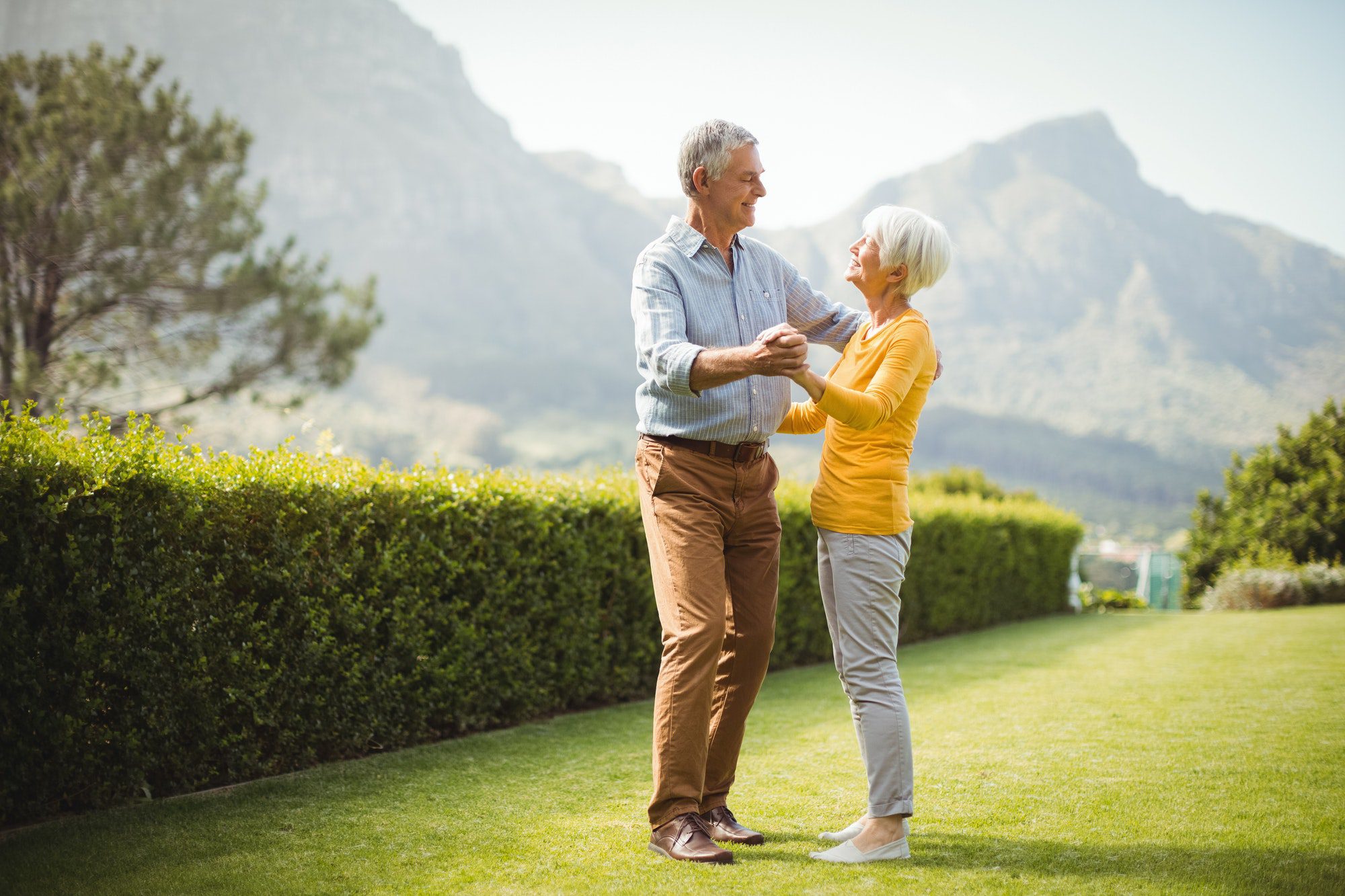 Senior couple enjoying a dance in the park as they discuss why its possible that Medicare Advantage is bad for them.