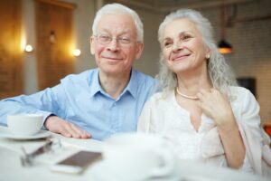 Seniors in cafe discussing Part B Premium increases.