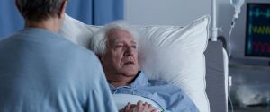 Senior in hospital bed thinking about Medicare coverage